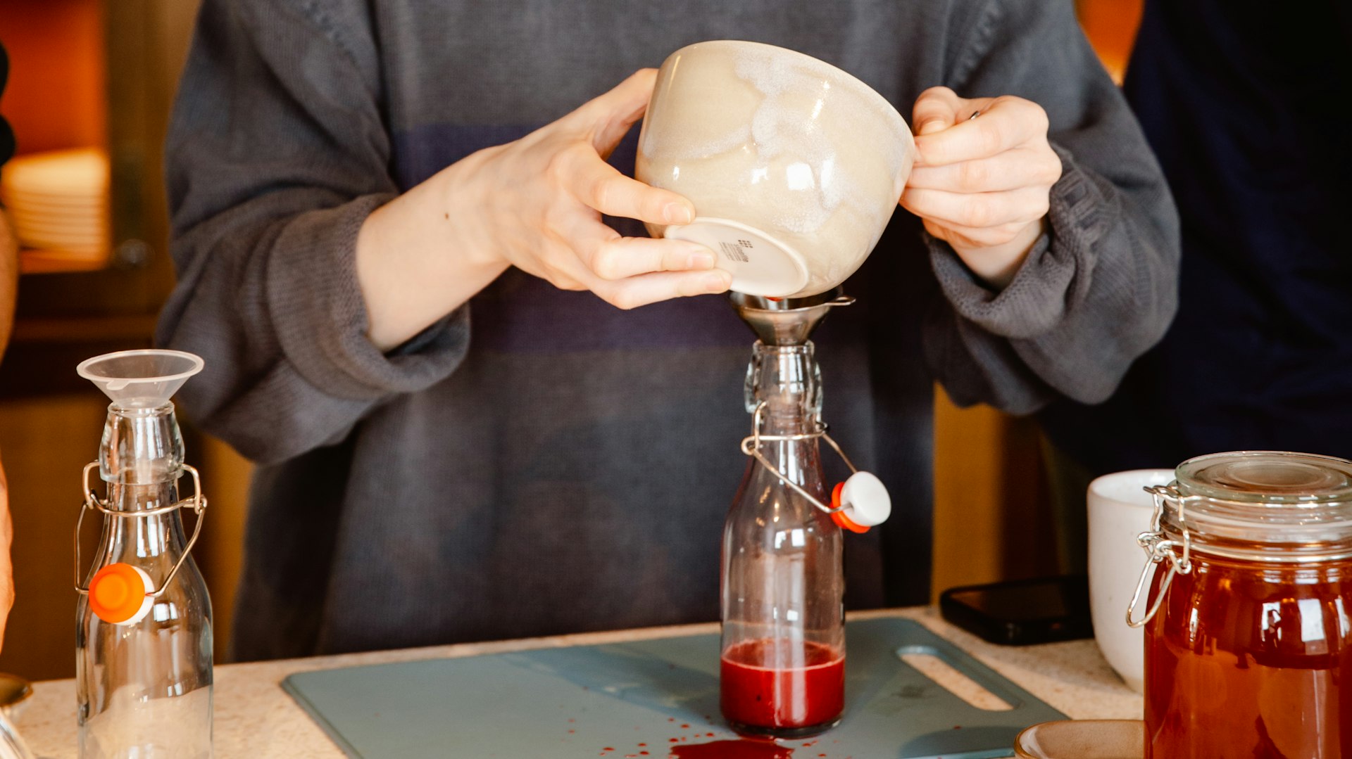 A lady makes kombucha