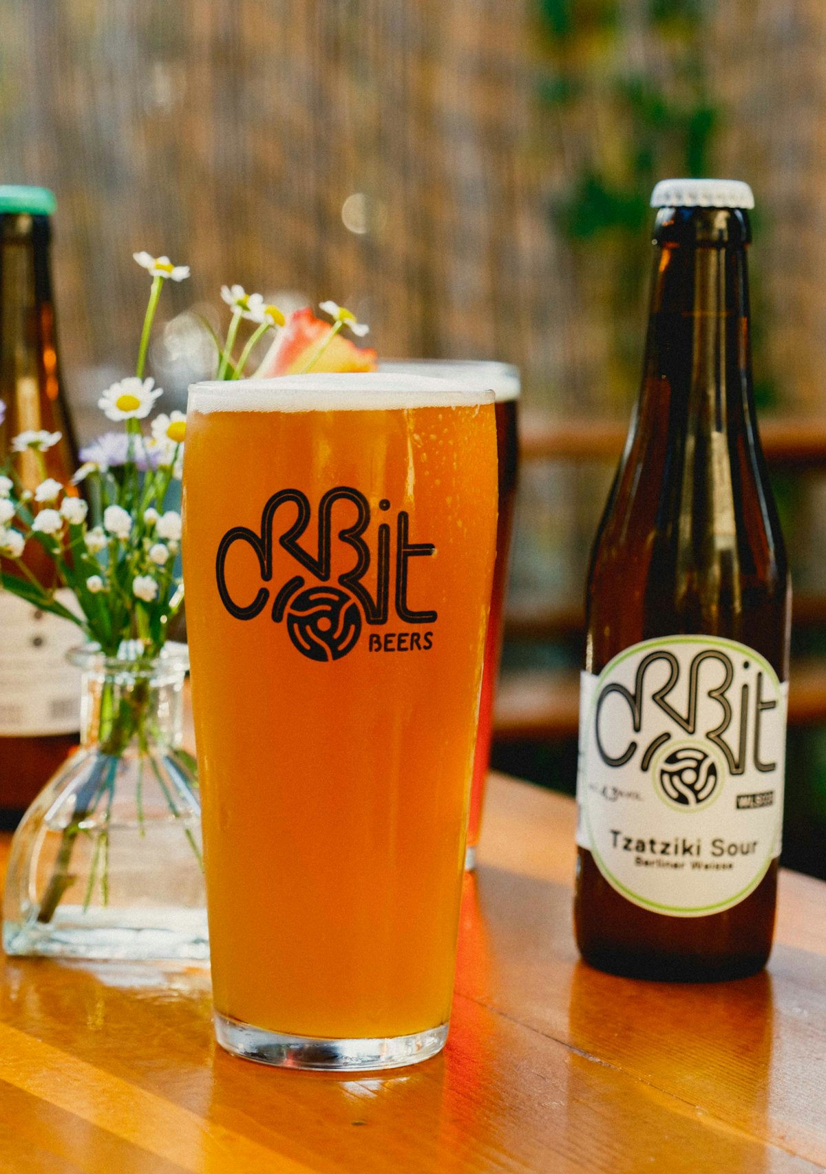 Bottles and pints of beer on a table