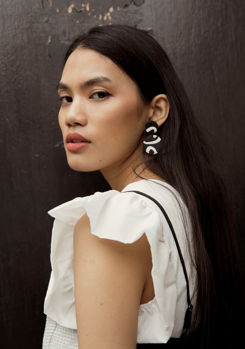 A lady wears a bold, statement earring