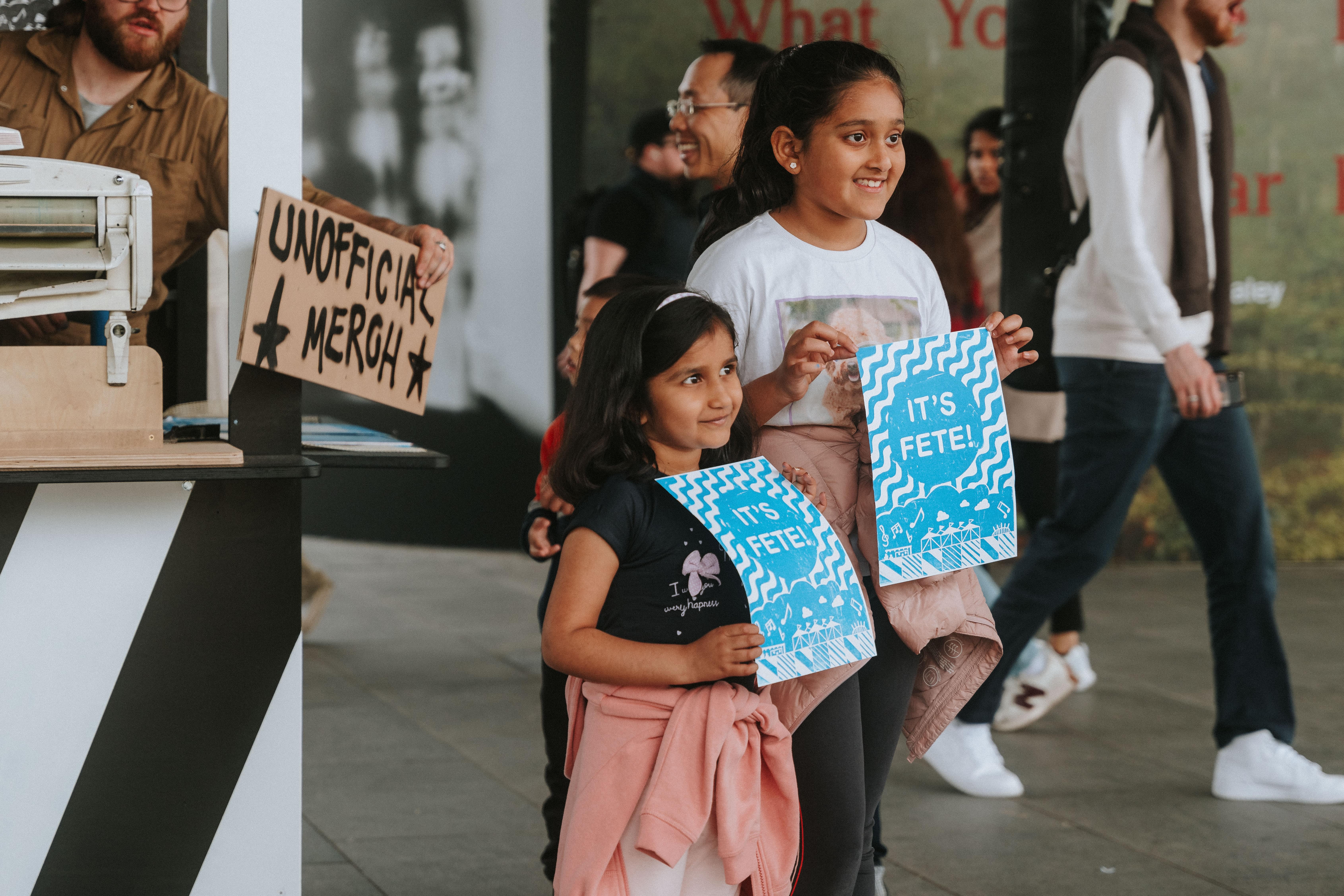 Two children holding their prints