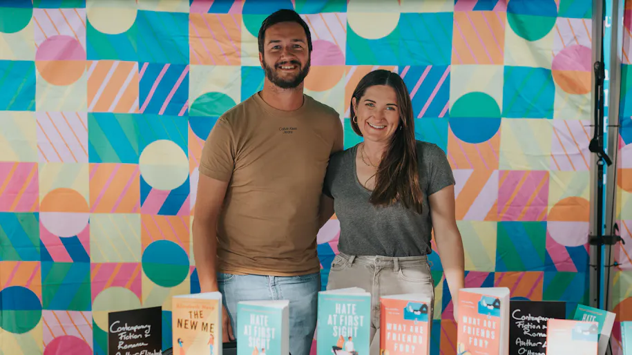 Man and woman at book stand