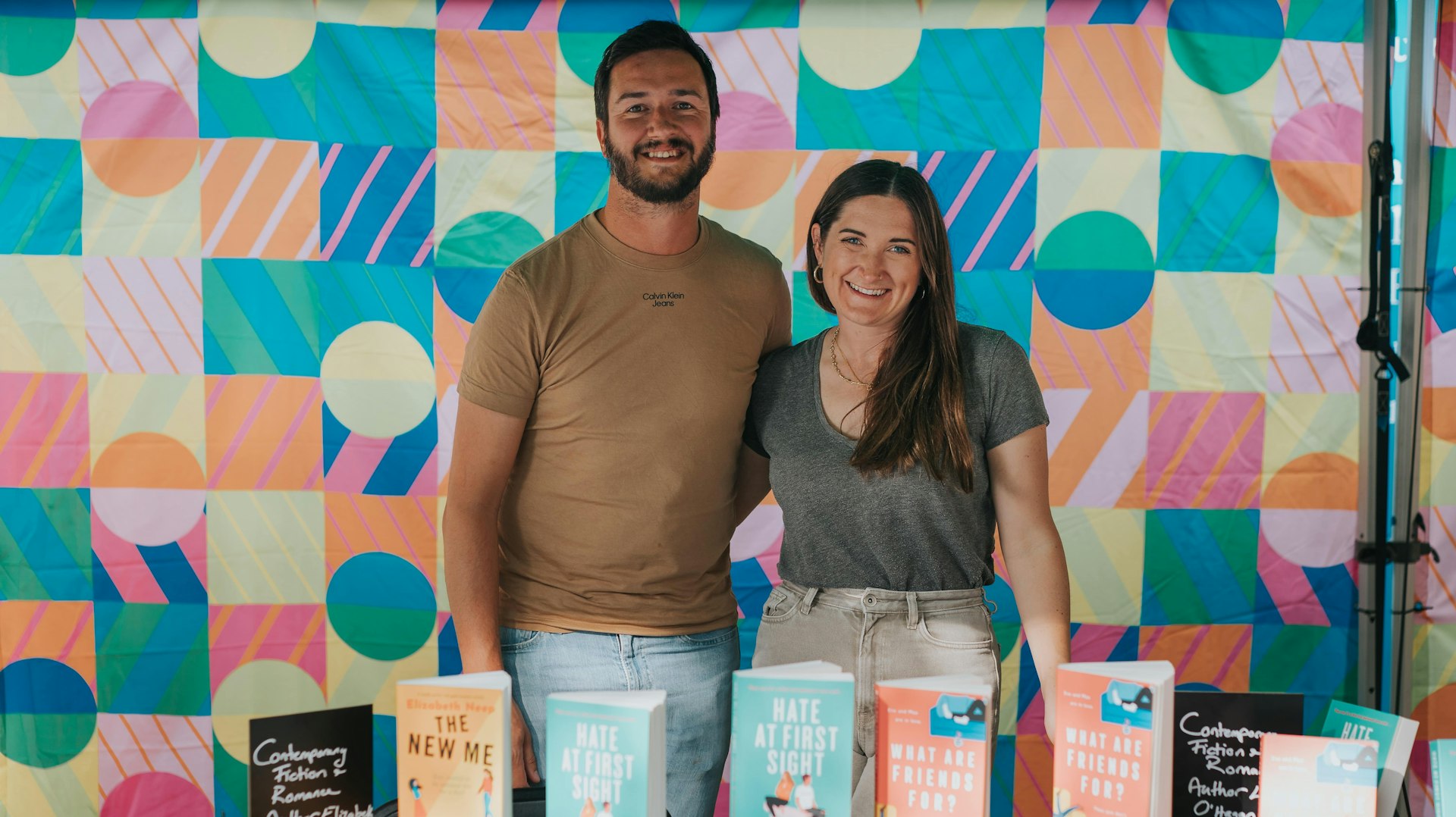 Man and woman at book stand