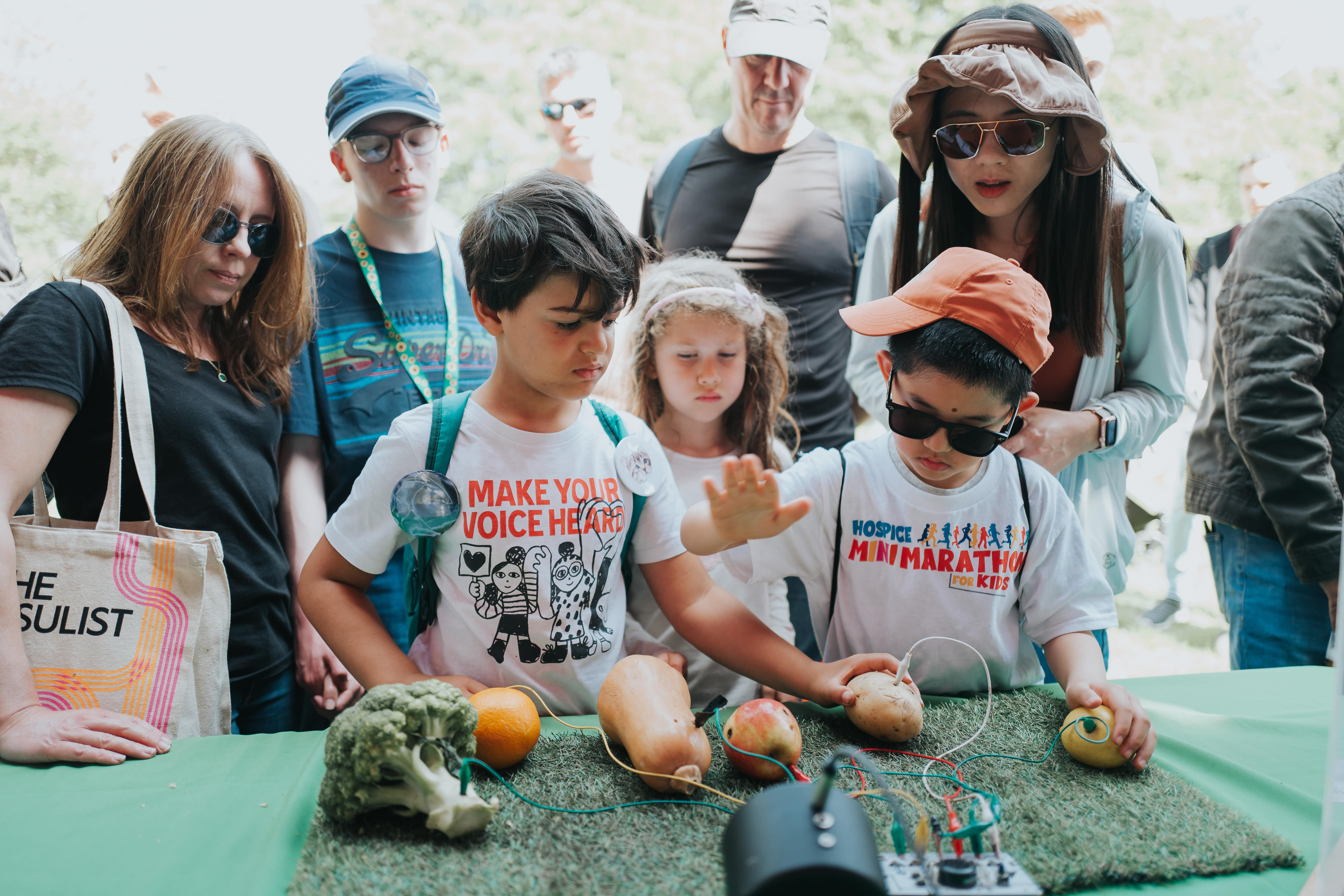 Two children experiment with the science apparatus