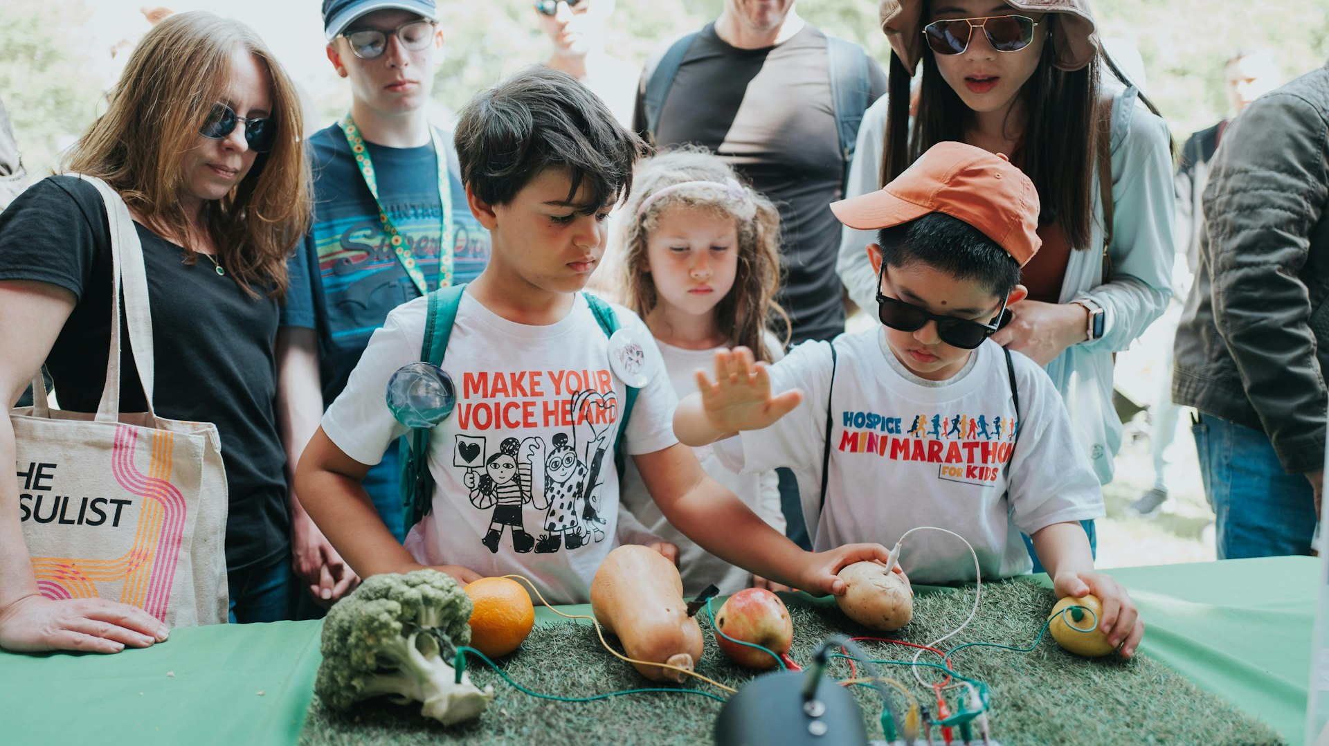 Two children experiment with the science apparatus