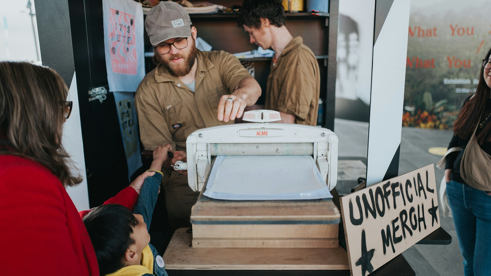 A man and woman stand at a printer