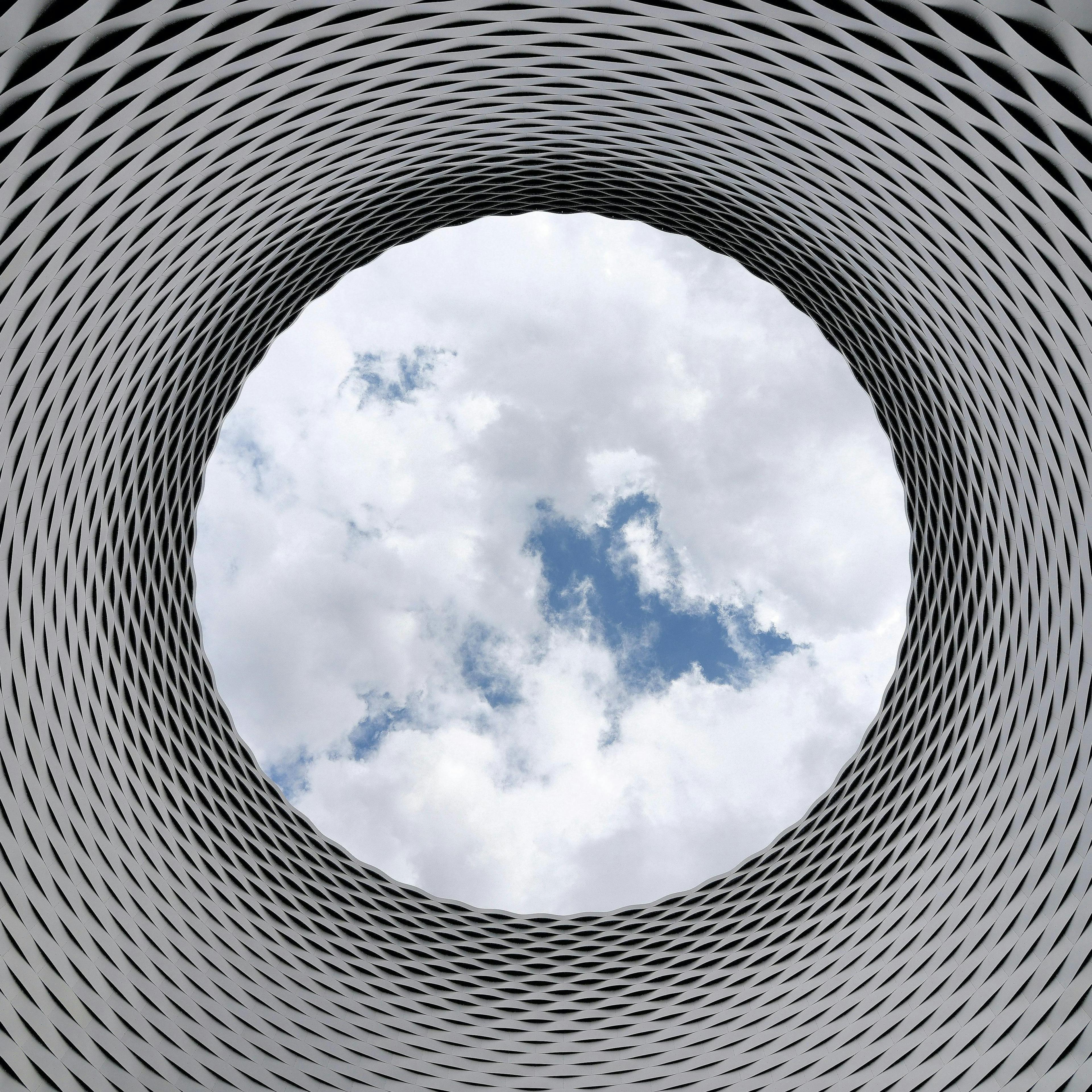 https://www.pexels.com/photo/low-angle-photography-of-grey-and-black-tunnel-overlooking-white-cloudy-and-blue-sky-210158/
