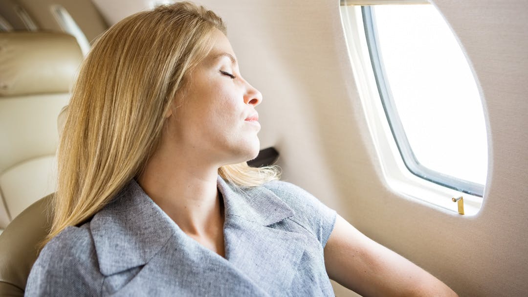 A woman enjoys a relaxing flight on a chartered plane