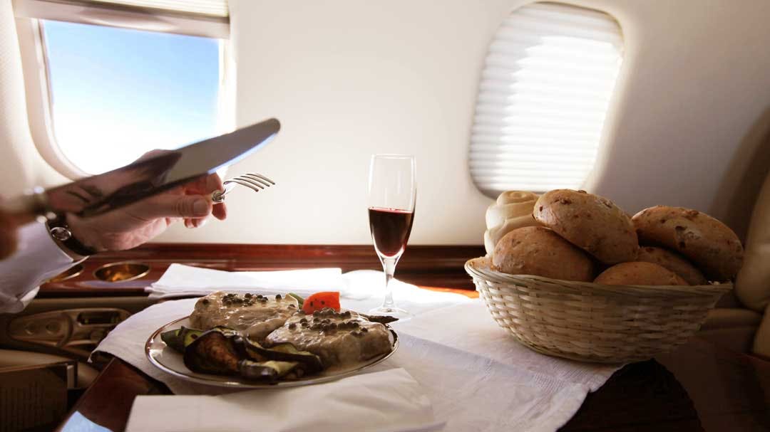 A private charter passenger enjoys a gourmet breakfast onboard their flight