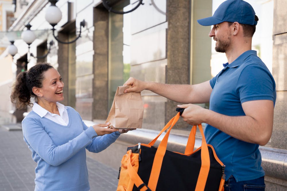 Driver delivering the food to lady 