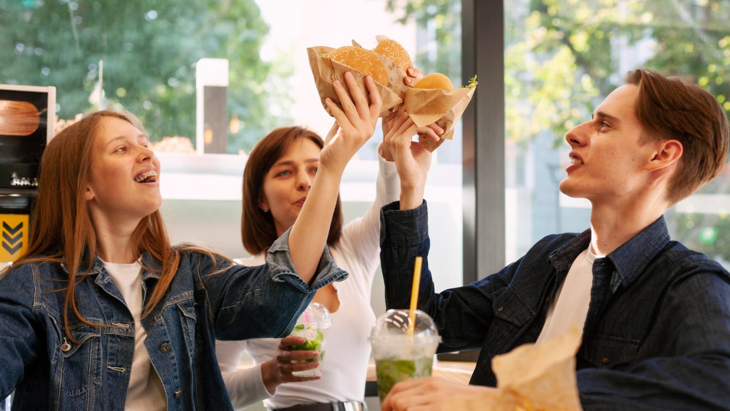 Friends toasting burger