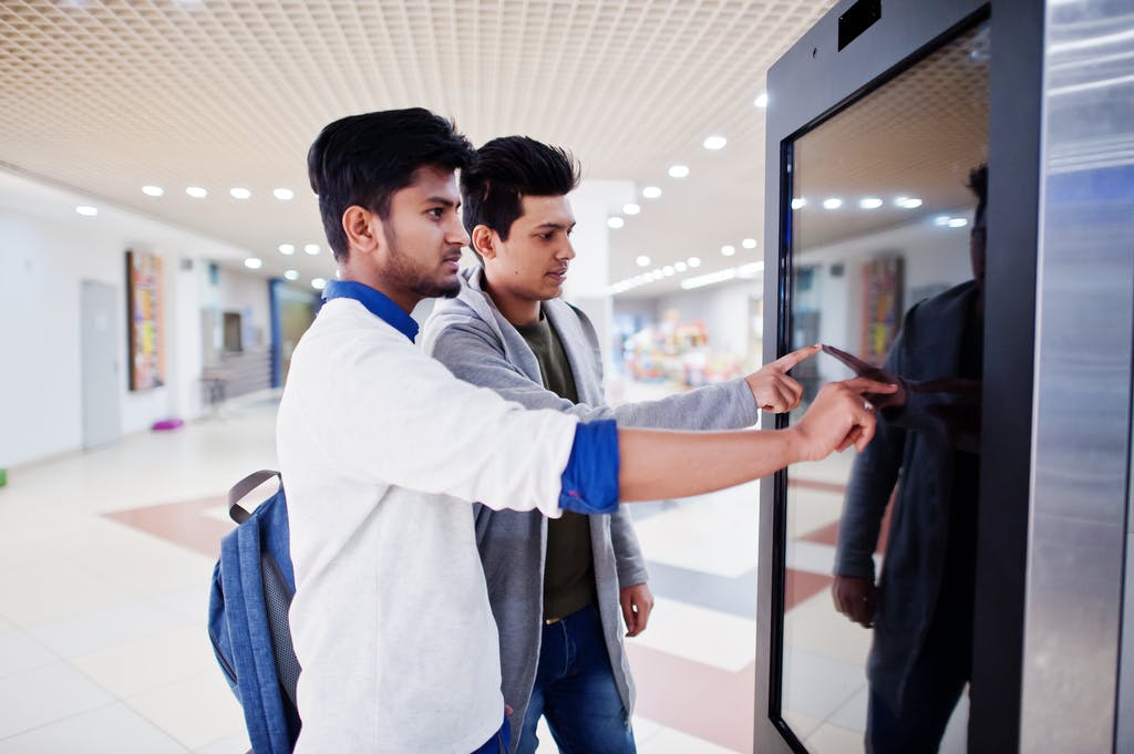 Two People Using Kiosk