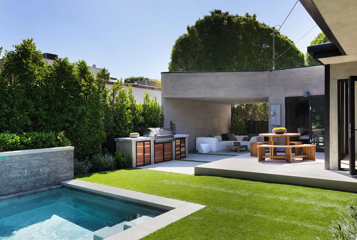 West Hollywood project — backyard with limestone tile, plunge pool, and honed limestone water feature wall