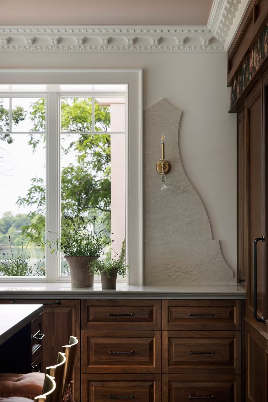 wooden cabinet with Montaaj surface on it and a window behind it