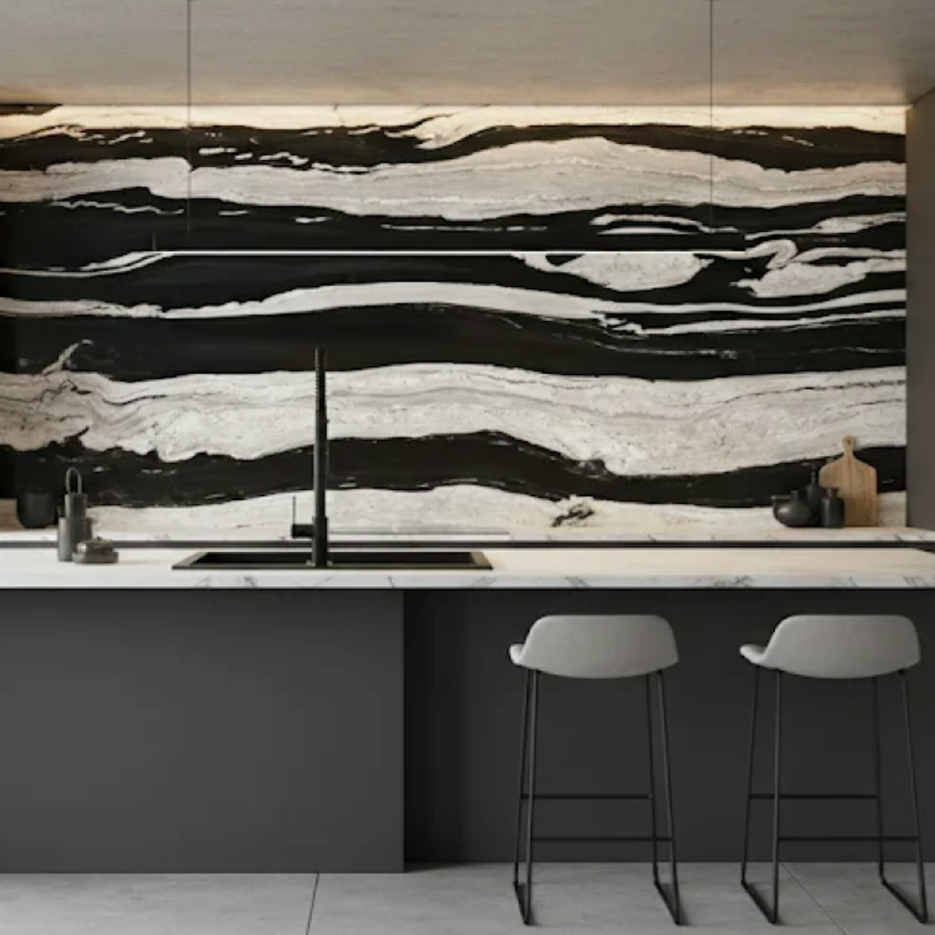 Kitchen countertop with black and white slab cladding on the wall behind it