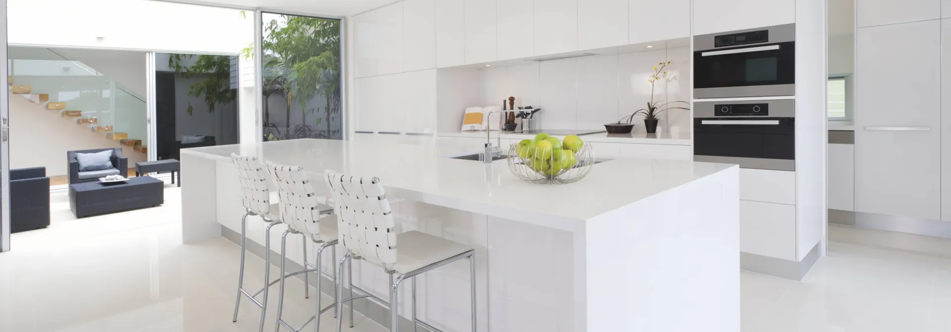 white acrylic countertop with green apples in a bowl on it 