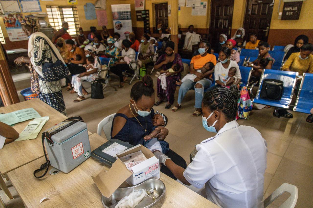 Nurse vaccinating children at health centre