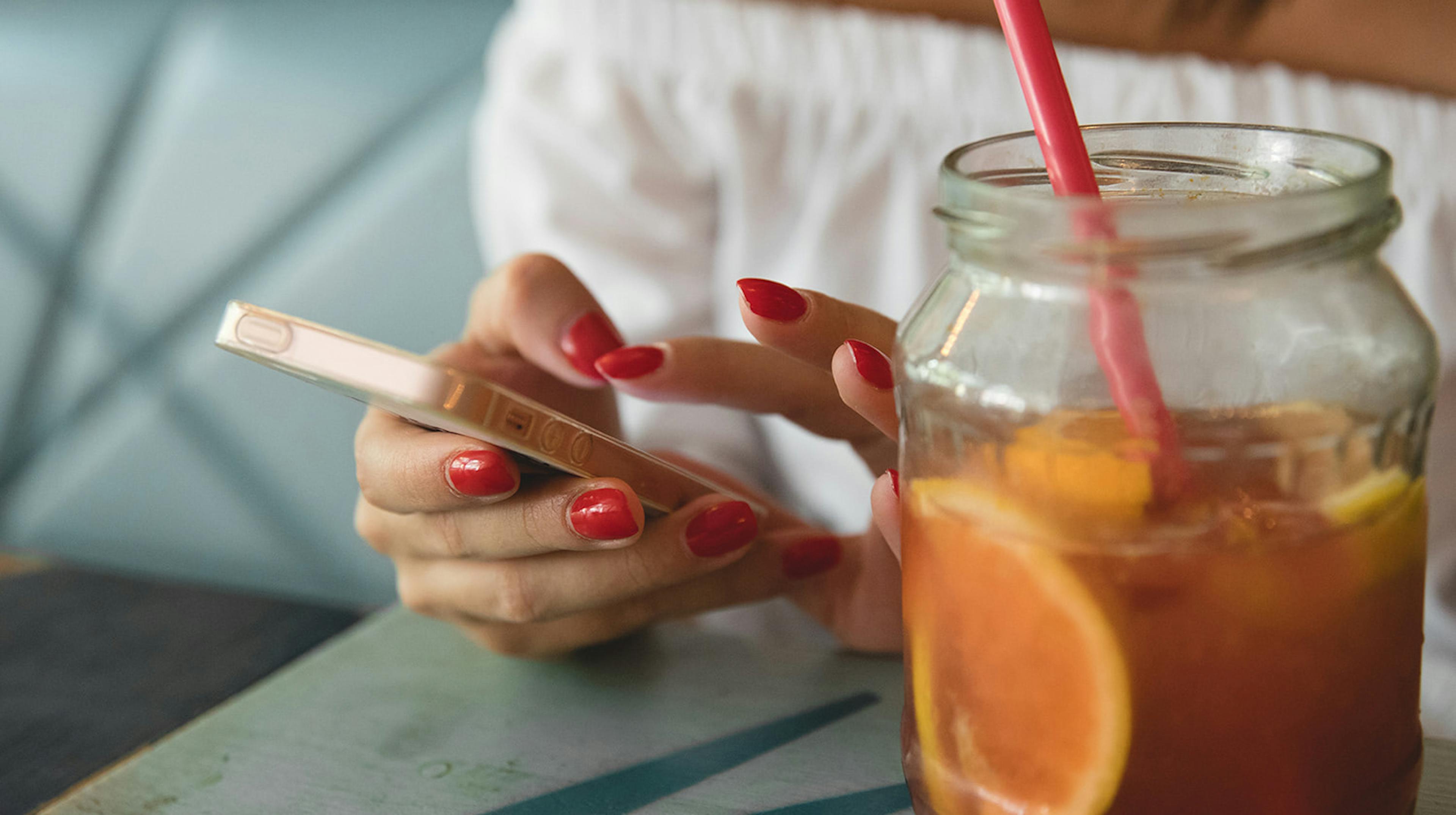 Woman scrolling her phone inside a cafe