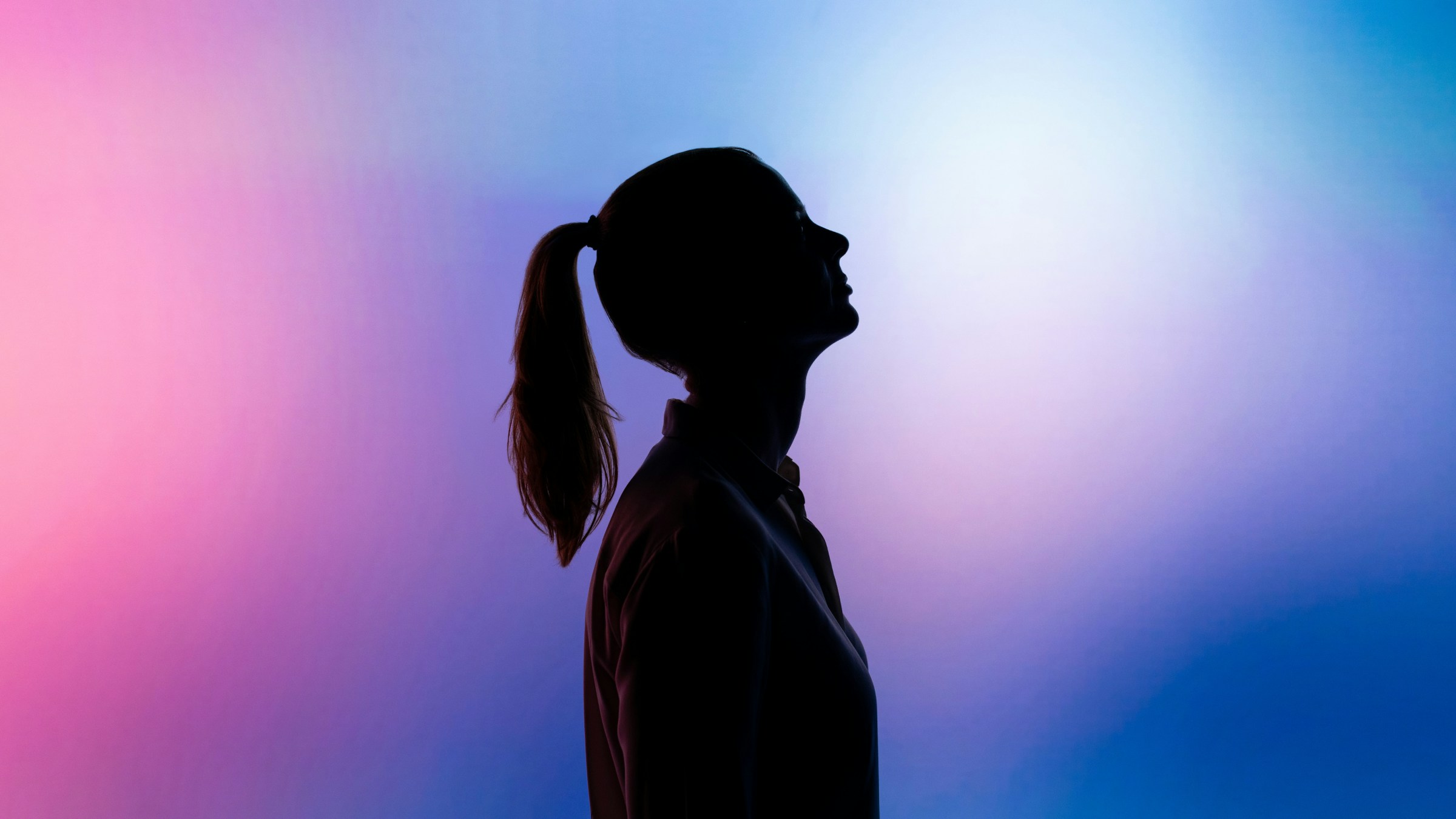 Silhouette of girl on coloured background