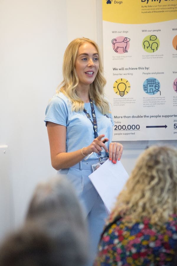 An expert fundraiser speaks to people at an event.