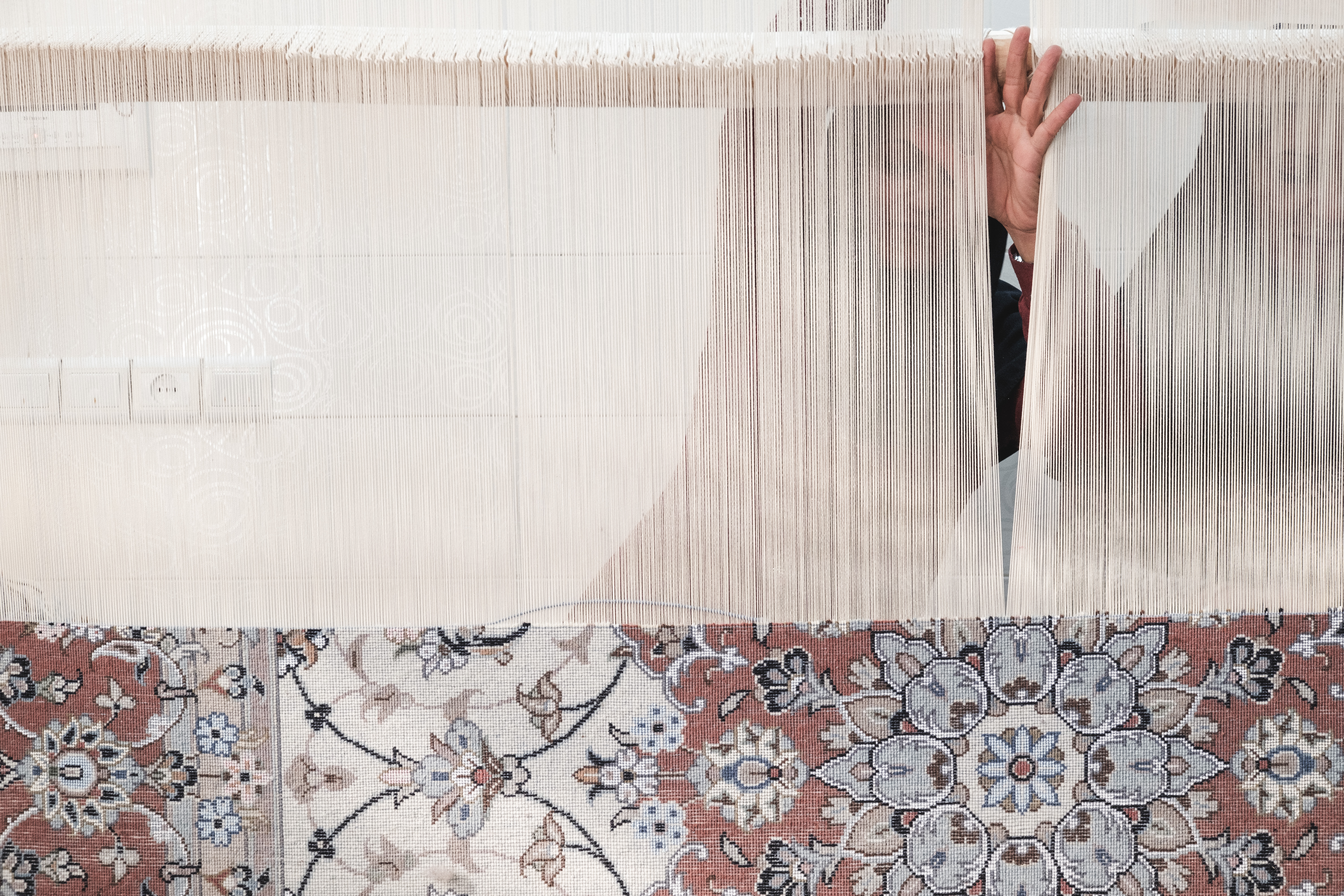 Carpet weaving in a family home Kashan, Iran. November 2018 Photograph: Guido van Helten