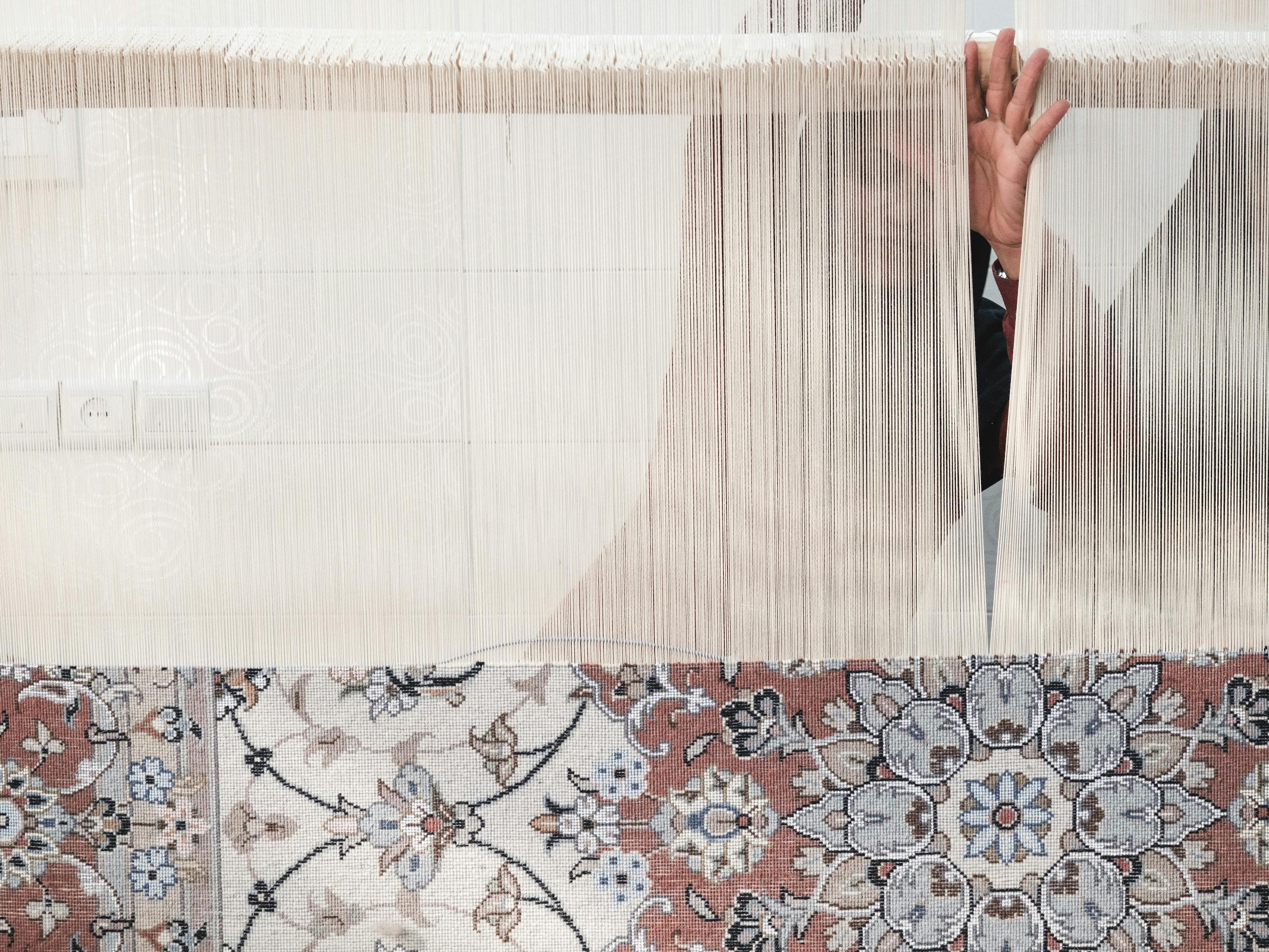 Carpet weaving in a family home Kashan, Iran. November 2018 Photograph: Guido van Helten
