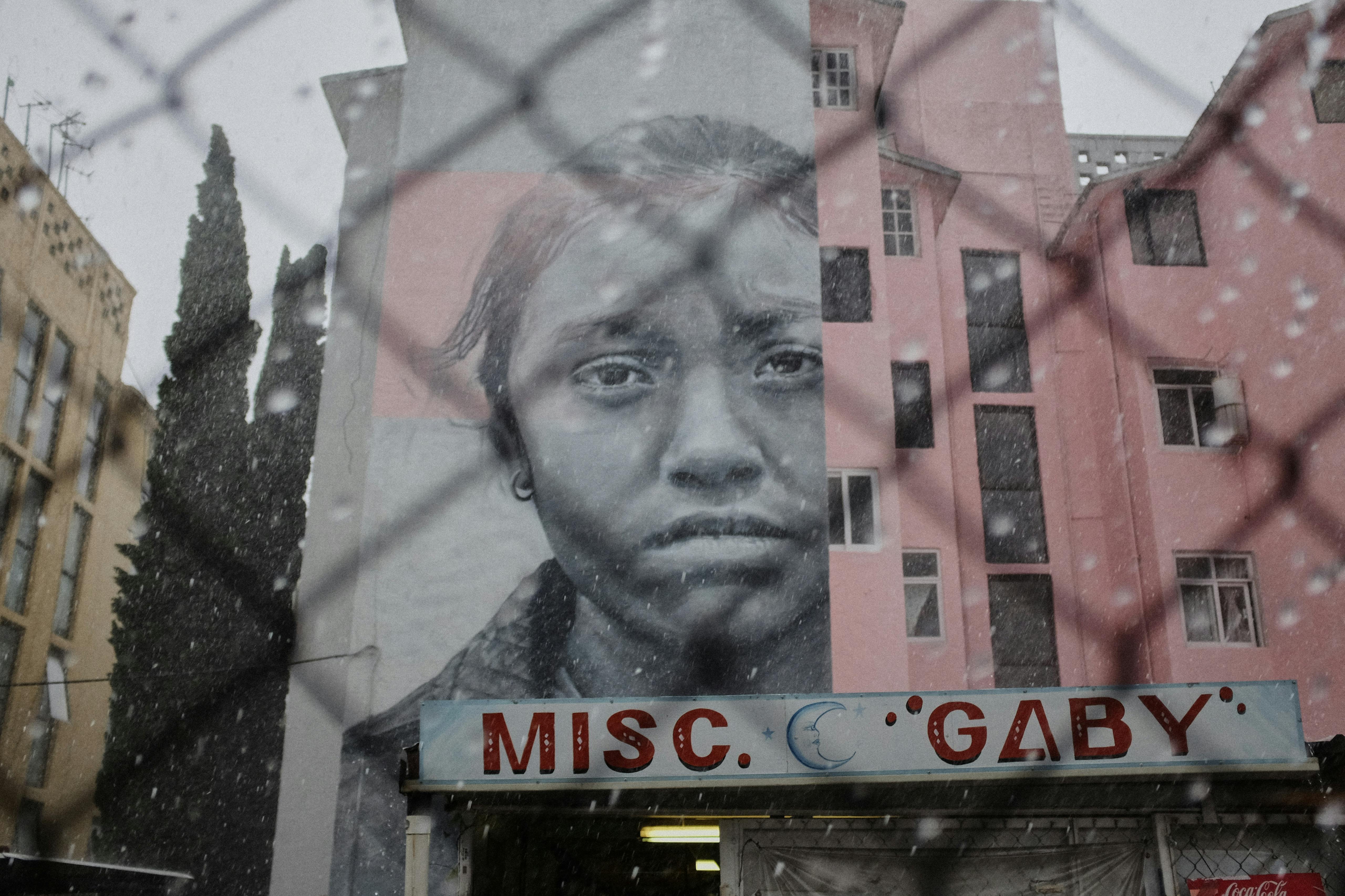 Work in progress during summer storms, Ecatepec, Estado de México, Mexico. July 2016 Photograph: Guido van Helten