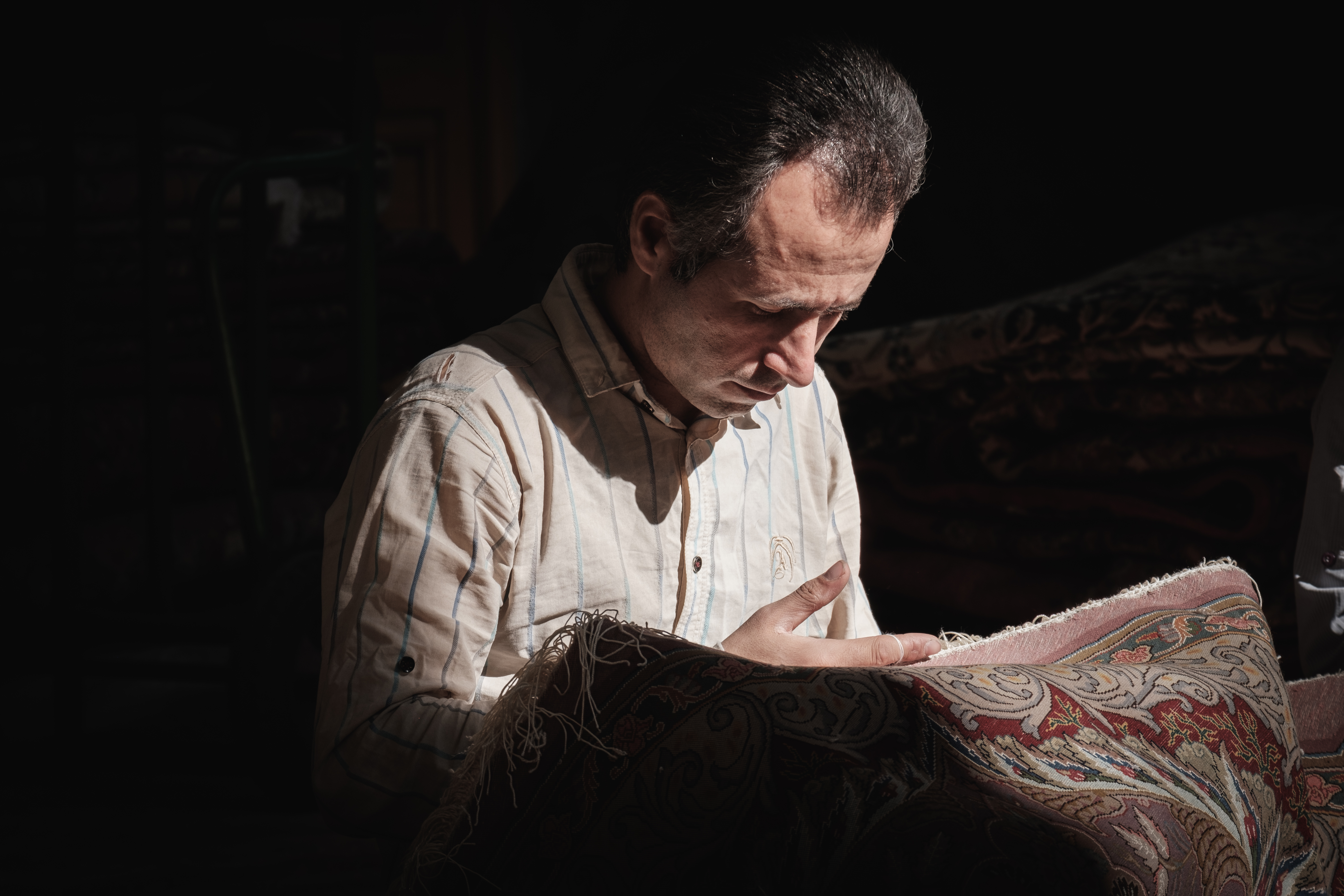 A Carpet worker in Tehran's Central Bazaar Tehran, Iran. November 2018 Photograph: Guido van Helten