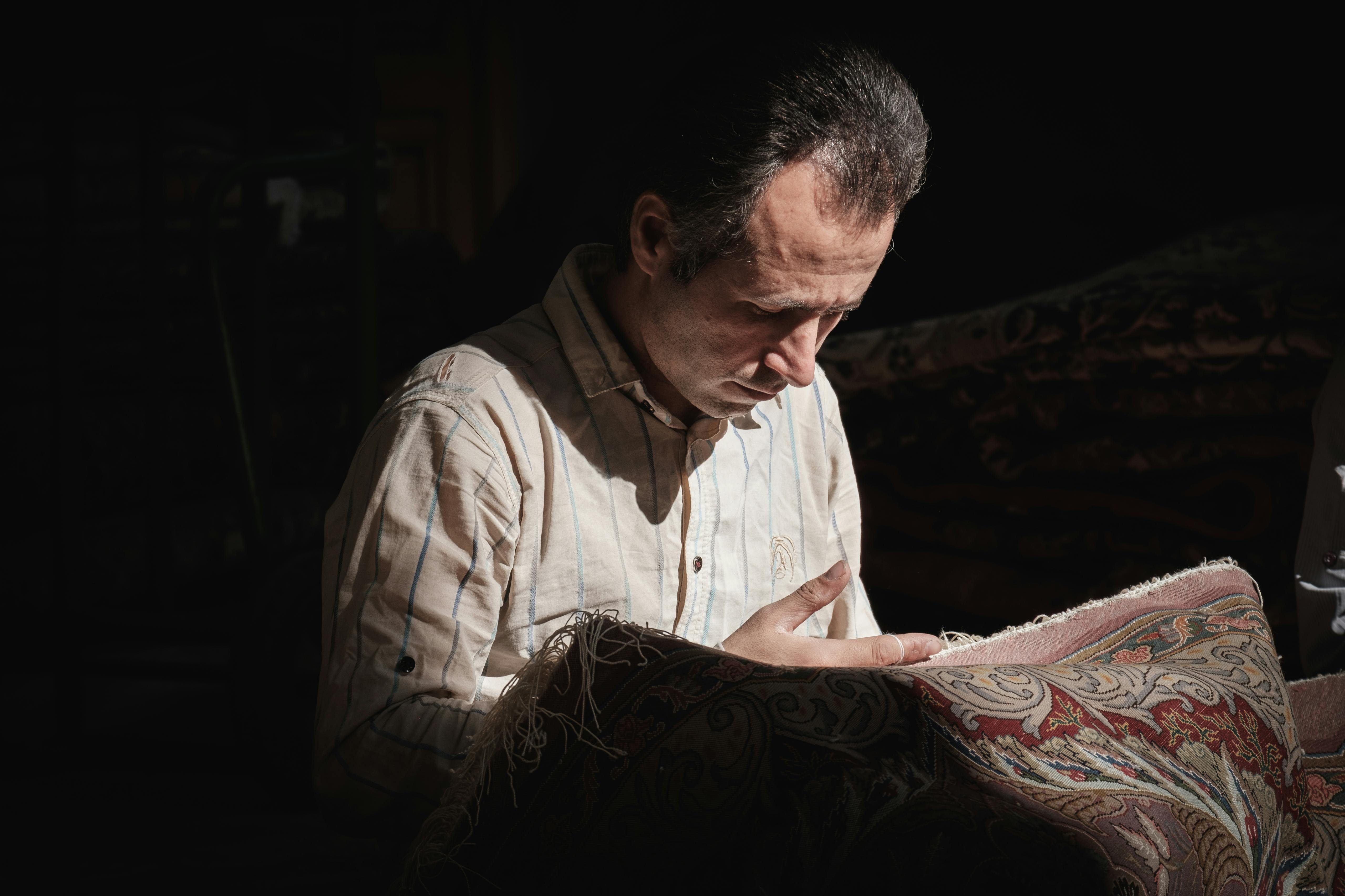 A Carpet worker in Tehran's Central Bazaar Tehran, Iran. November 2018 Photograph: Guido van Helten