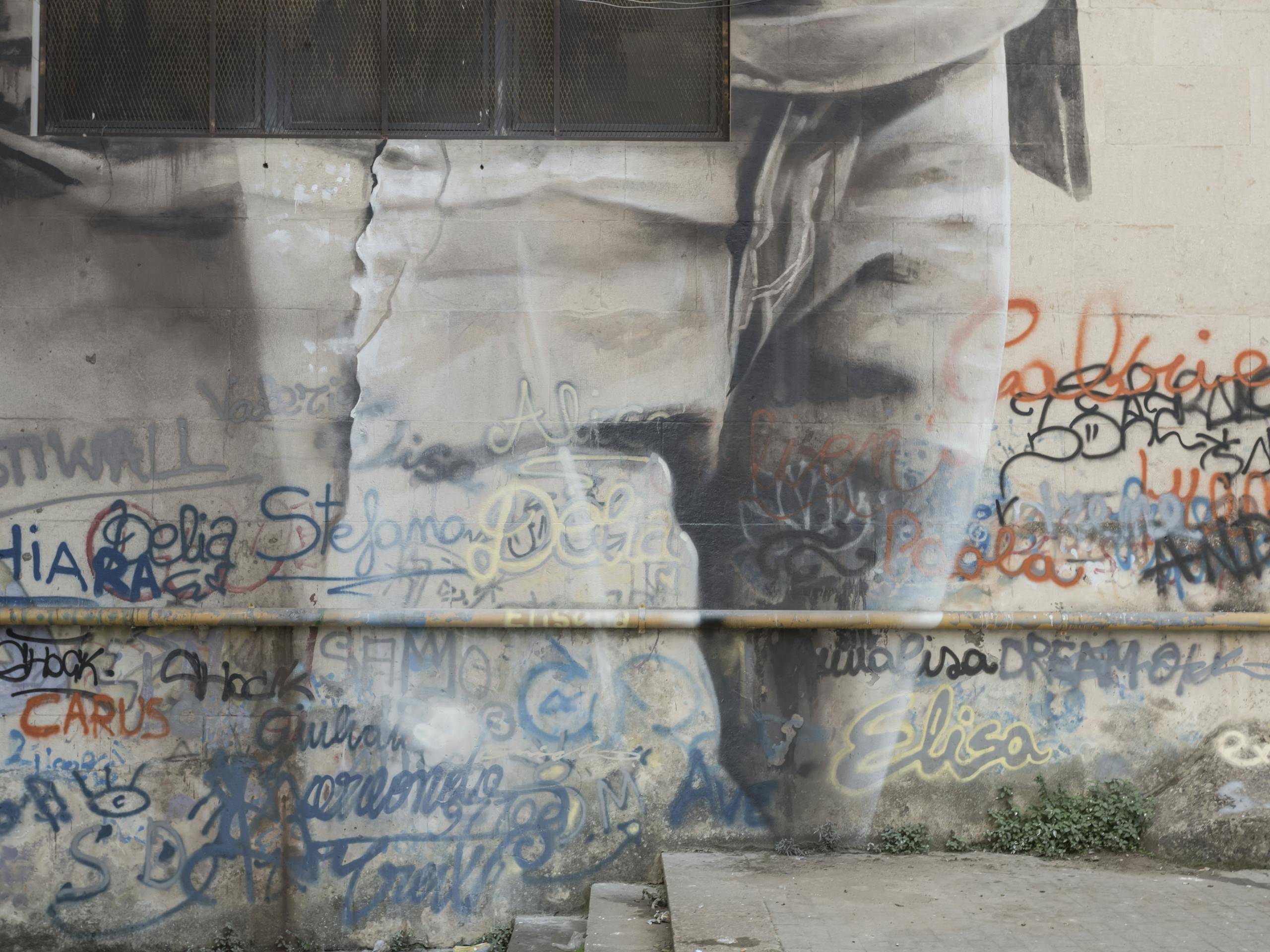Integration of student graffiti - mural detail. Ragusa, Sicily, Italy. October 2017 Photograph: Marcello Bocchieri