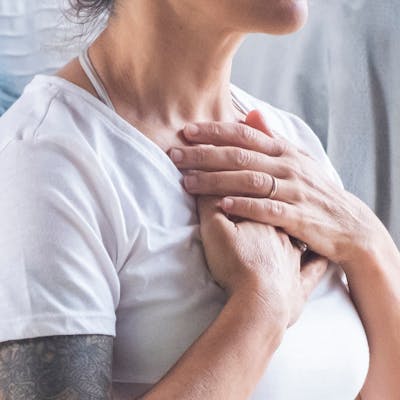 Frau atmet mit Händen über der Brust Frau atmet mit Händen über der Brust