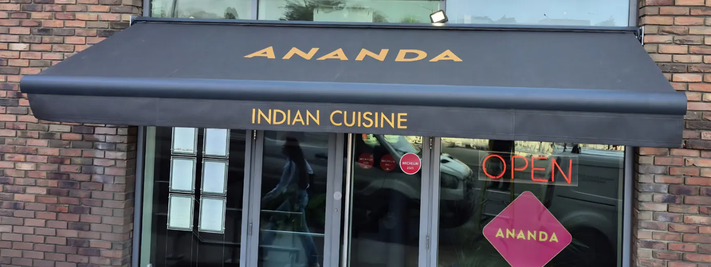 Ananda Indian Cuisine storefront with navy awning and open sign