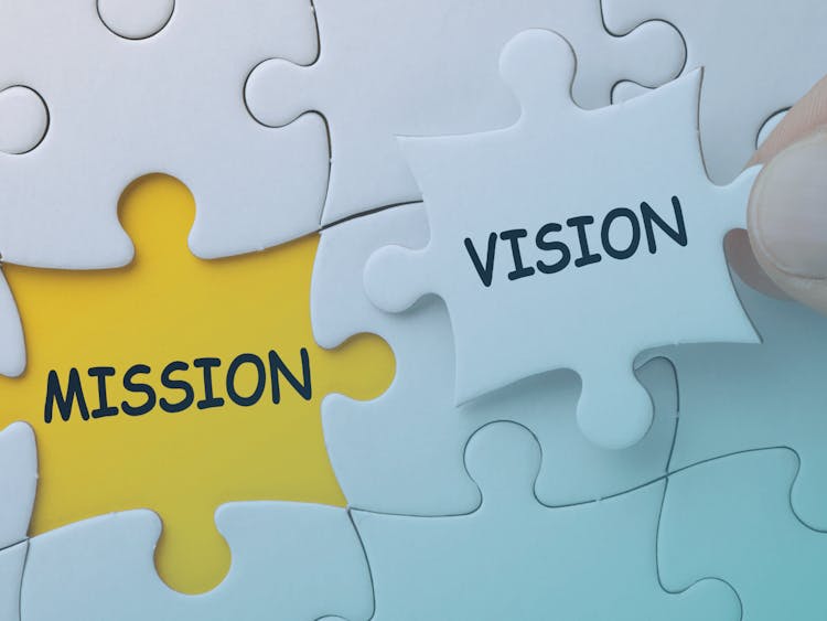 A puzzle includes mission and vision pieces.