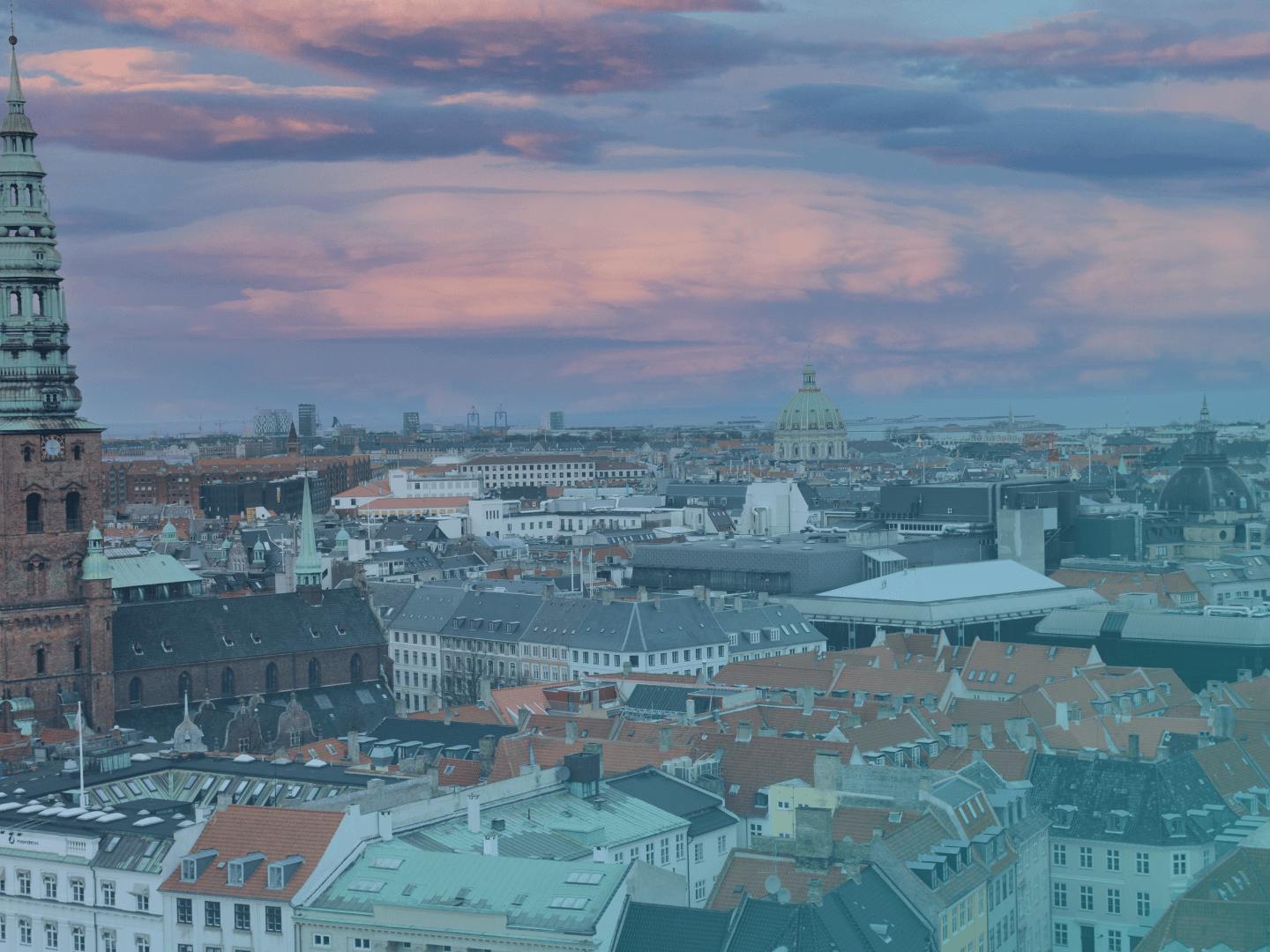 A view of a city in Denmark from the top. Old, stylish buildings are surrounding the city.