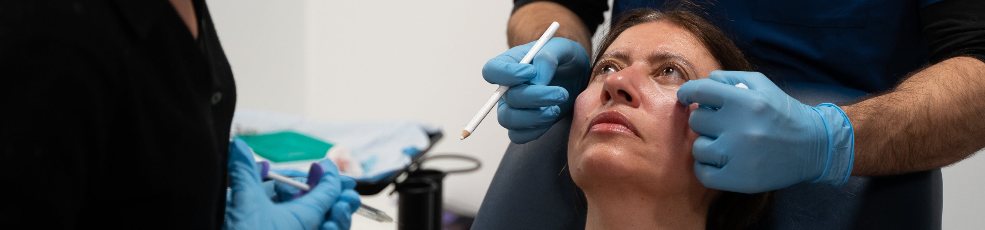 Cosmetic doctor assessing a patient for cheek filler during Harley Academy medical aesthetics training one-to-one mentoring session