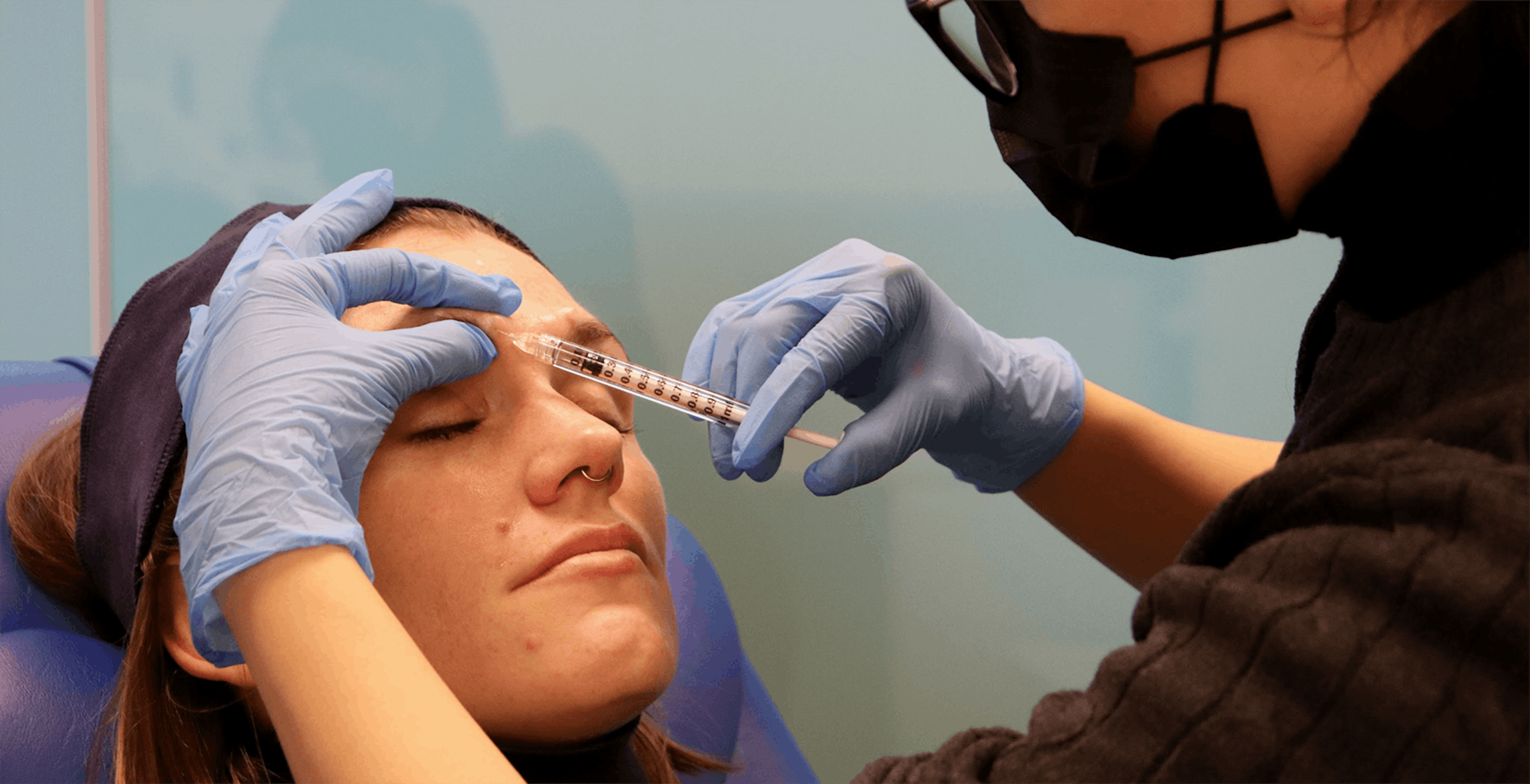 Female patient receiving forehead injectable treatment