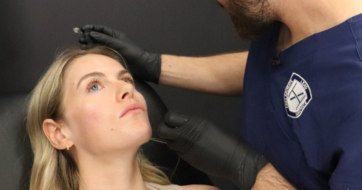 assessing dermal filler patient mid-treatment