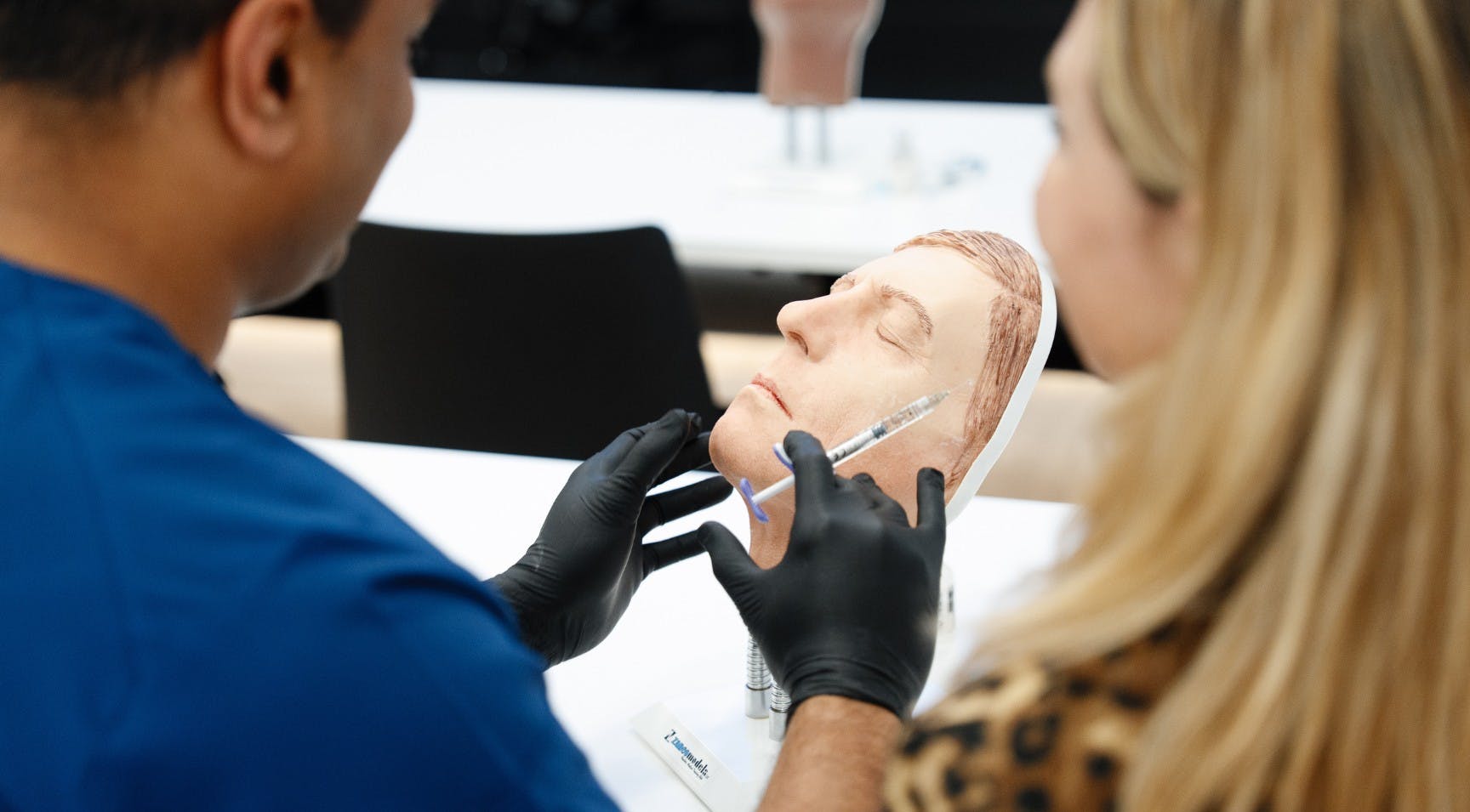 Learning to inject dermal filler with mannequin work during a medical aesthetics course for beginners