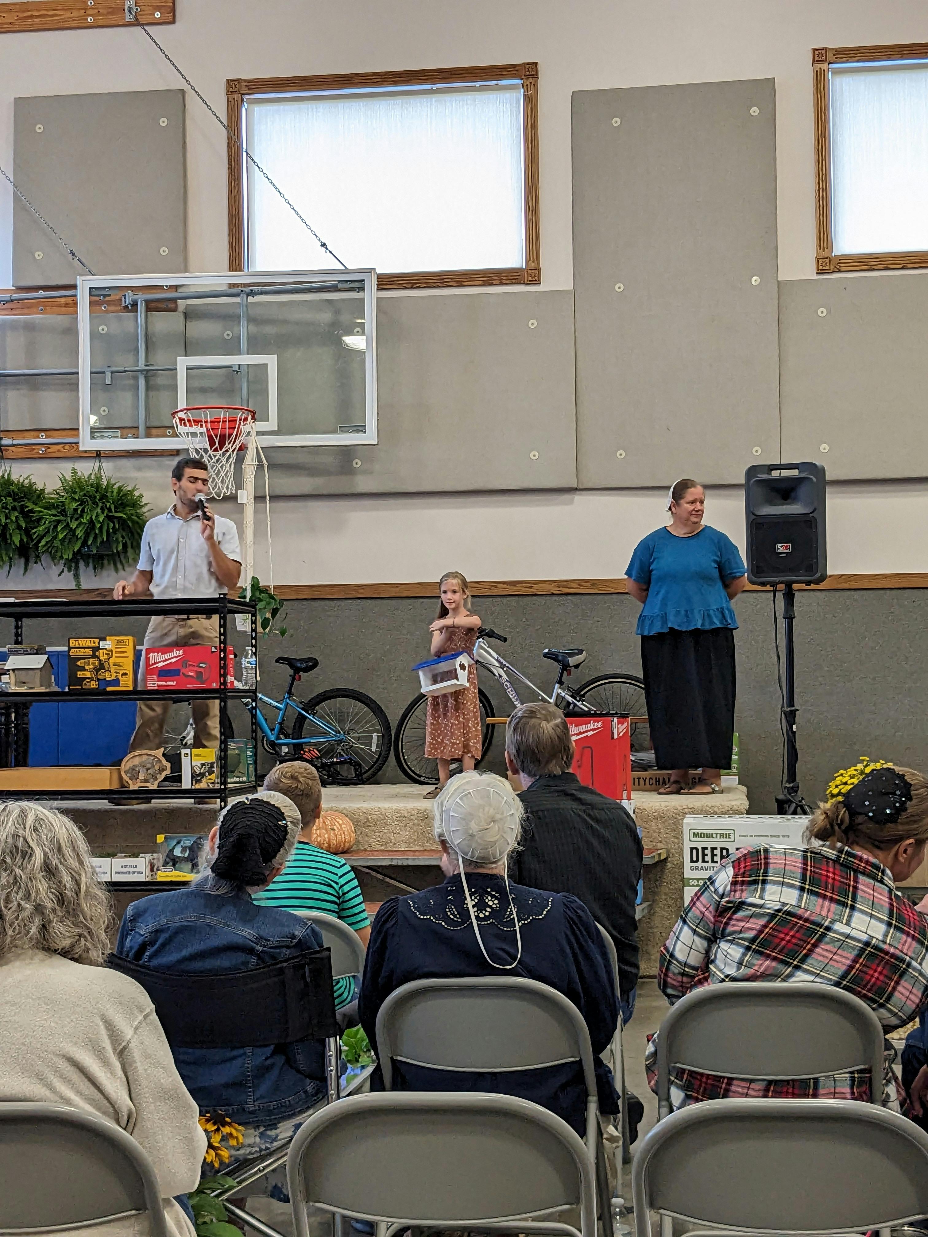 Auctioneer selling a student's craft.