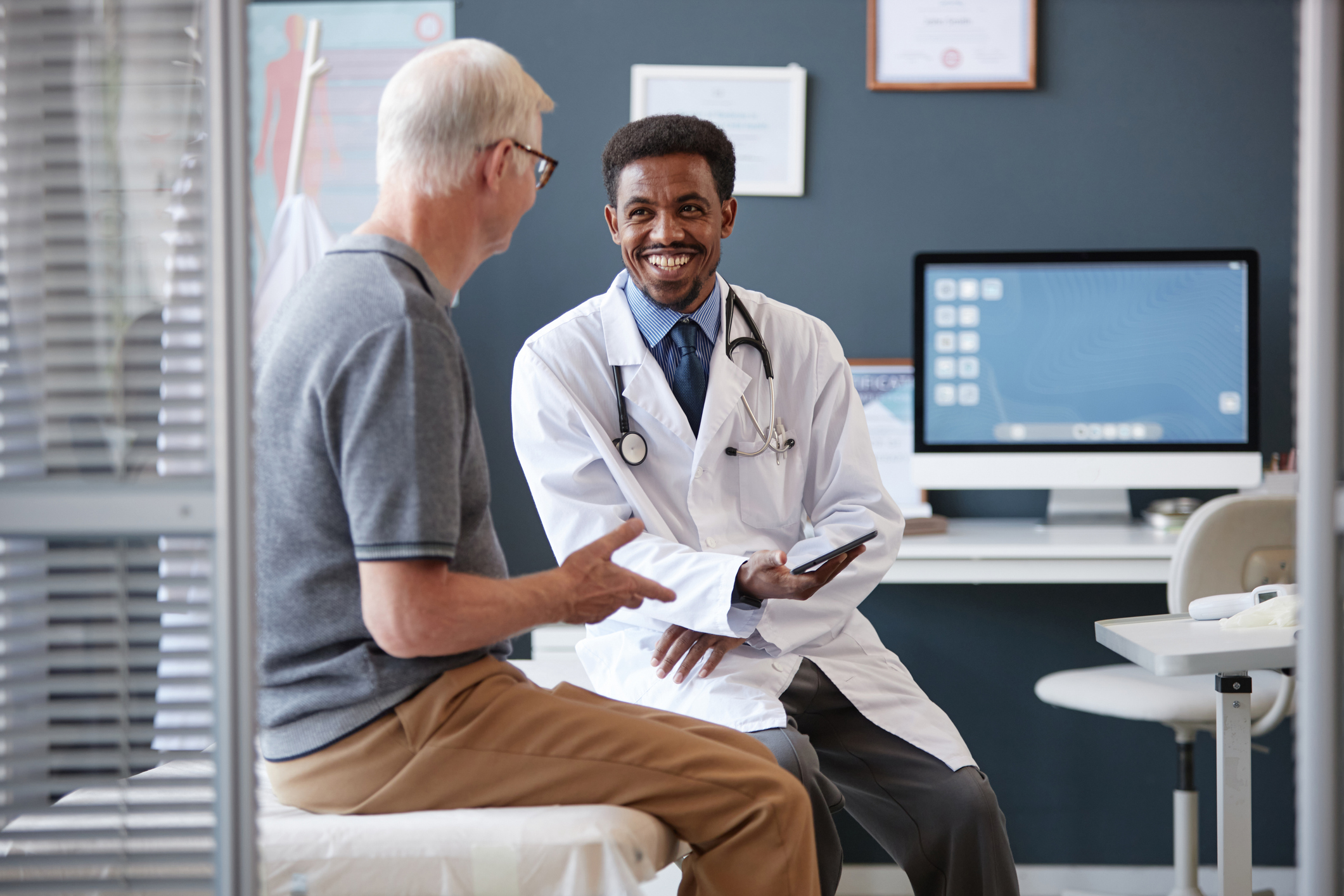 Male doctor having a discussion with his male patient