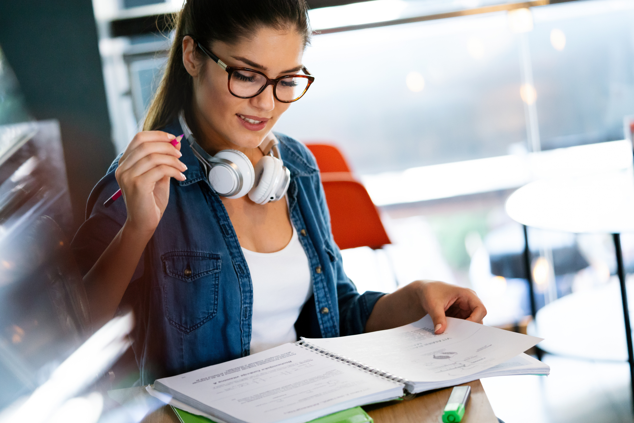 Female students holding a pencil and looking at her notebook