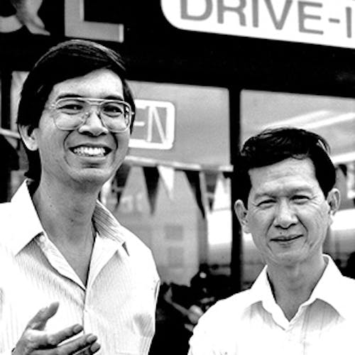 Vintage photo of two men standing in front of an L&L location