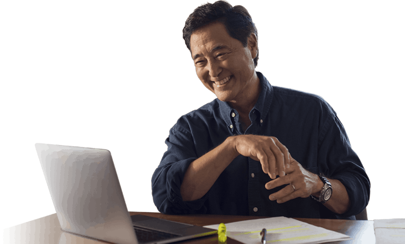 man working and smiling at desk