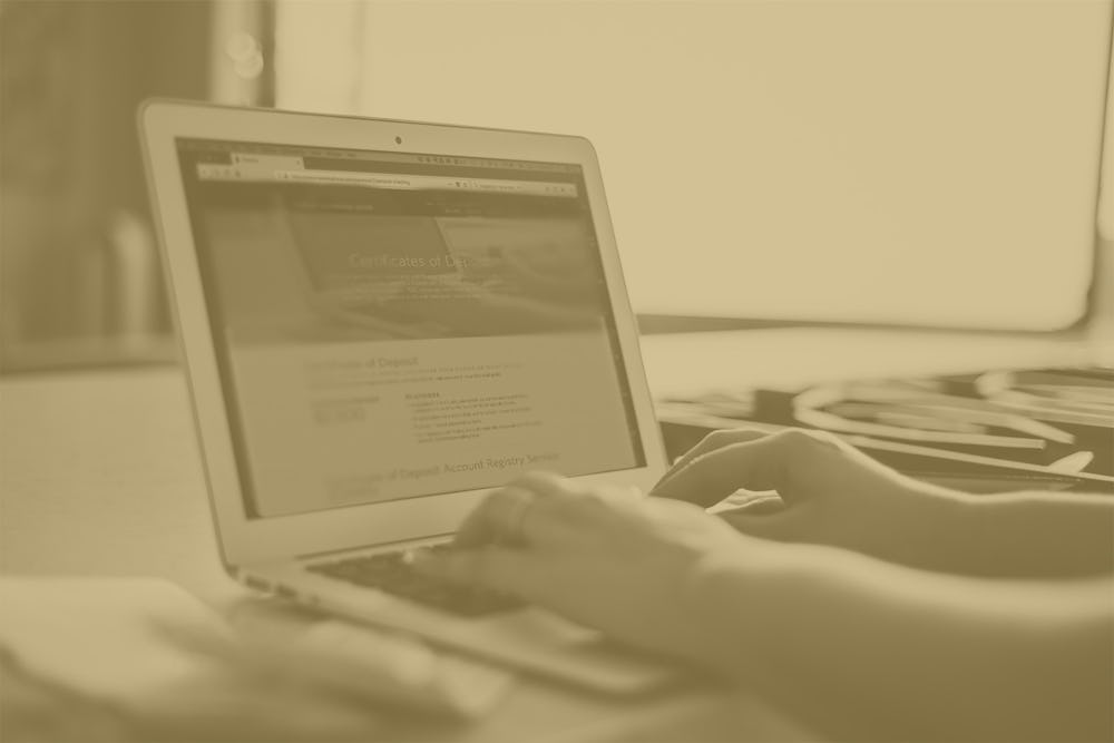 photo of hands typing on laptop