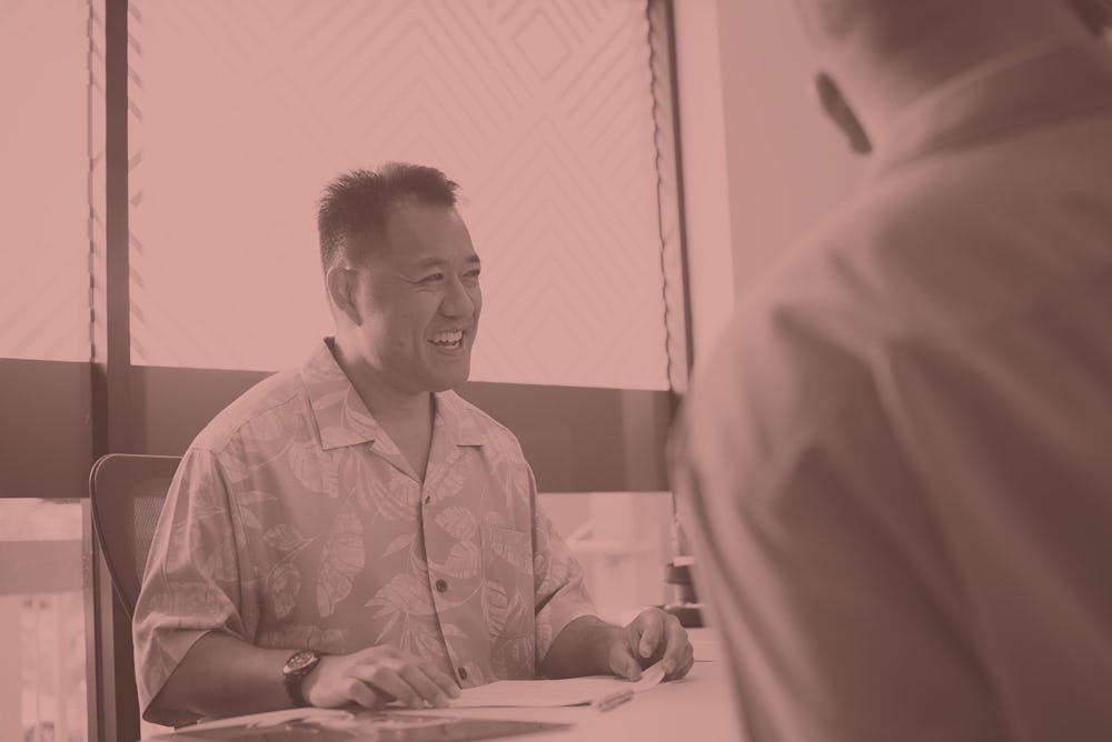 bank employee smiling at customers