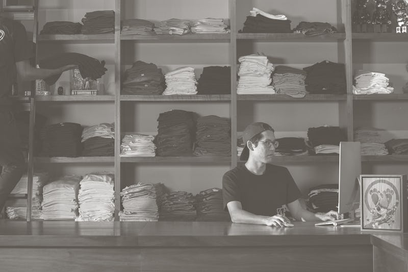 two business employees stocking shelves