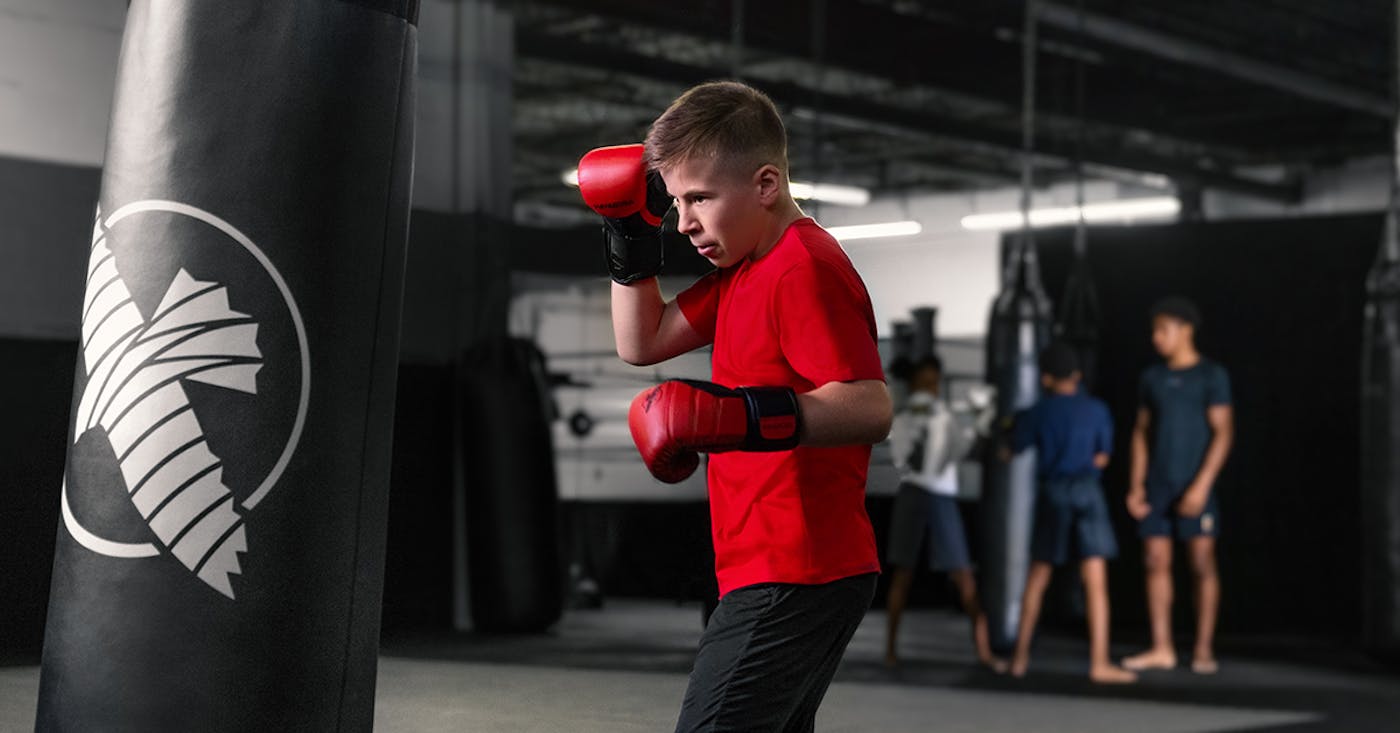 Youth practicing boxing in a gym
