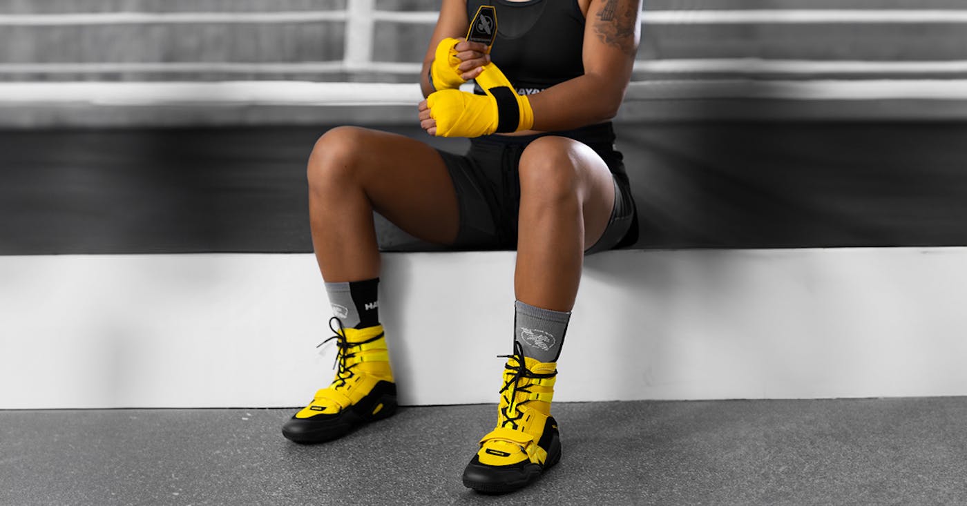 Boxing shoes and hand wraps, emphasizing protection and performance