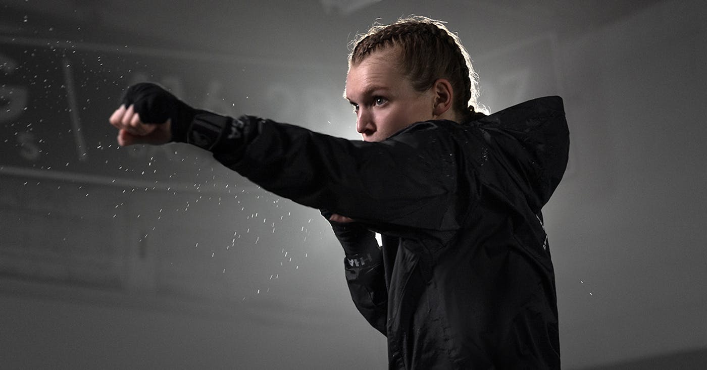 Boxer in a sauna suit engaged in boxing cardio, highlighting the importance of nutrition for fighters