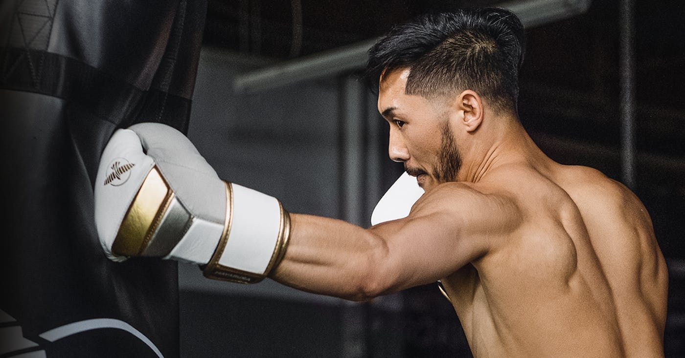 Punching heavy bag with Hayabusa T3 Boxing Gloves in boxing training session