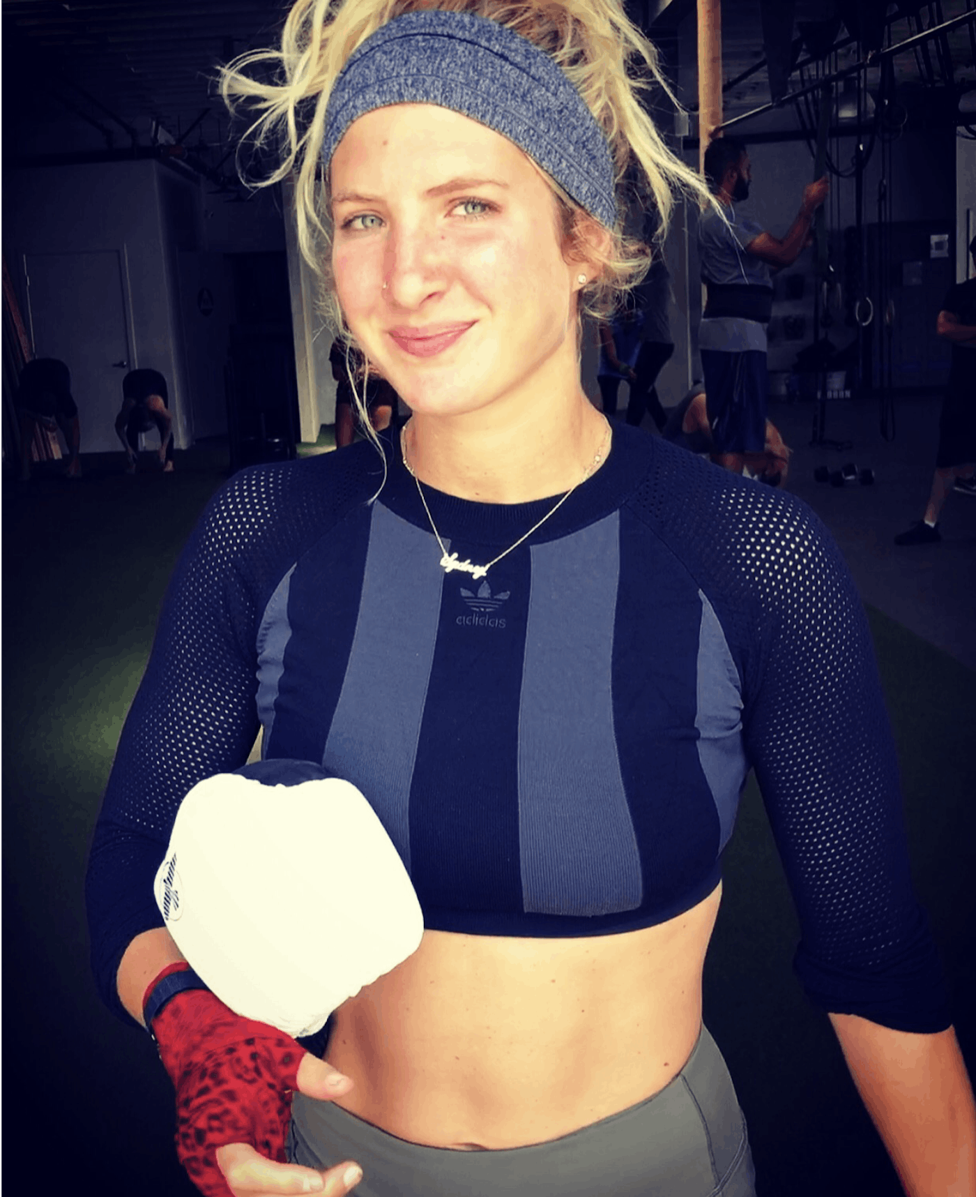 Sydney Rose Miller clutches a pair of Hayabusa T3 Boxing Gloves following a boxing workout. Your Fight. Worth It.